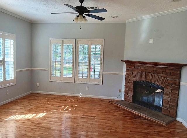 unfurnished living room with a fireplace, hardwood / wood-style floors, a textured ceiling, and plenty of natural light