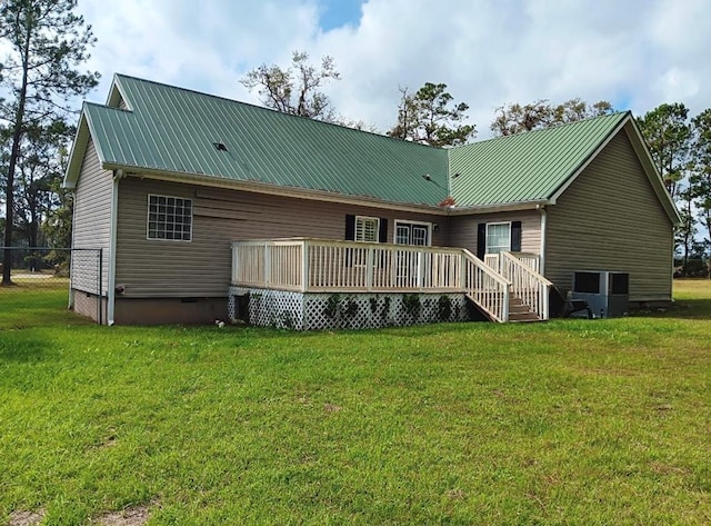 rear view of house with a yard and a wooden deck