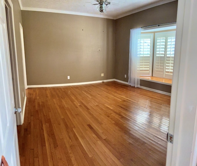 empty room featuring hardwood / wood-style floors, ceiling fan, and ornamental molding