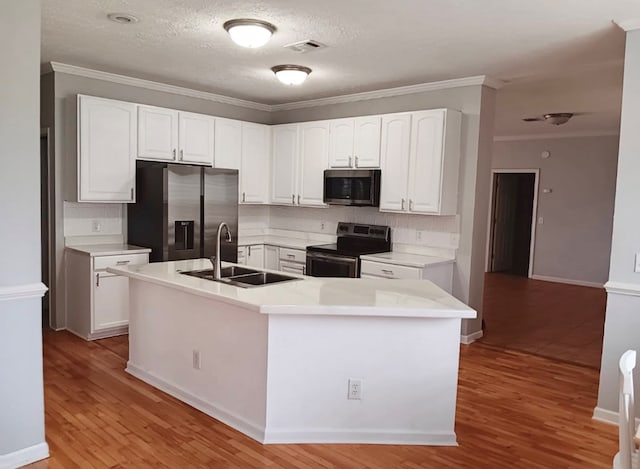 kitchen featuring white cabinets, light hardwood / wood-style floors, sink, and appliances with stainless steel finishes