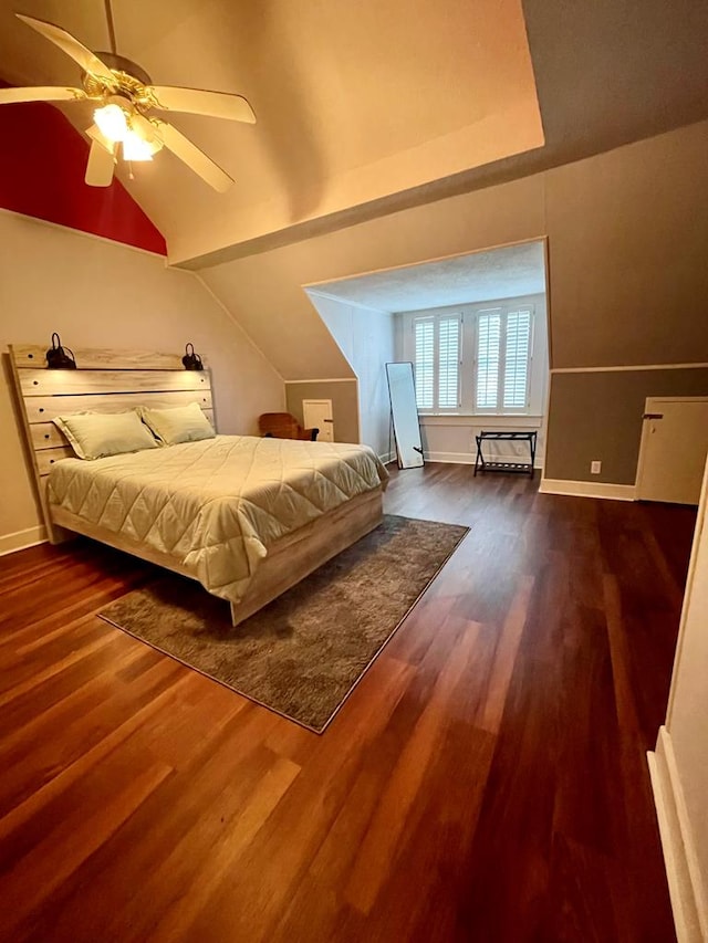 bedroom featuring baseboards, lofted ceiling, and wood finished floors