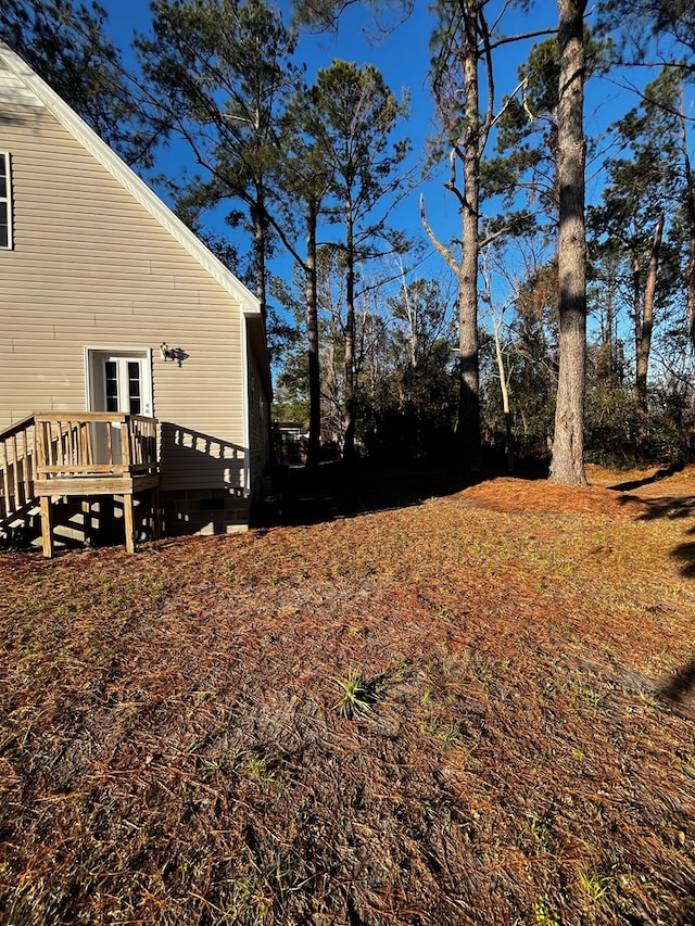 view of yard with french doors and a wooden deck