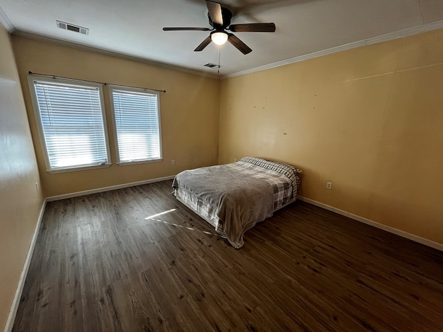 unfurnished bedroom featuring ceiling fan, dark hardwood / wood-style floors, and crown molding