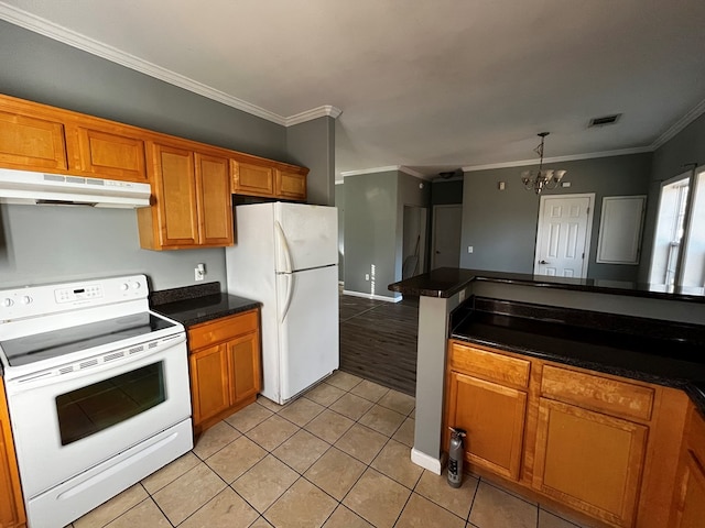 kitchen featuring white appliances, decorative light fixtures, a notable chandelier, light tile patterned floors, and crown molding