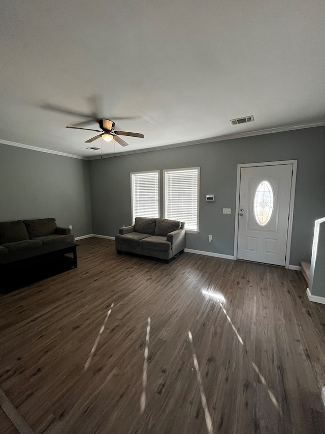 unfurnished living room featuring dark hardwood / wood-style flooring, ornamental molding, and plenty of natural light