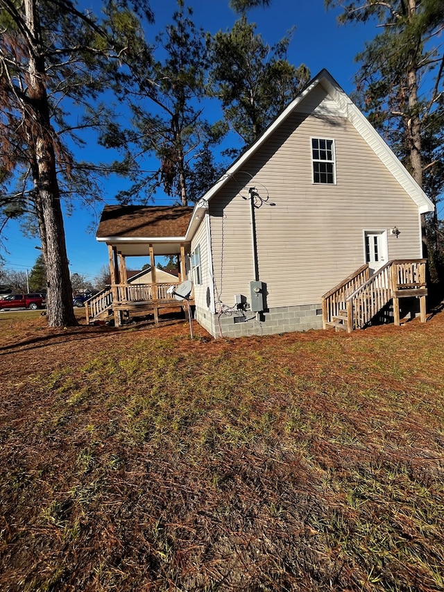 view of property exterior with a wooden deck