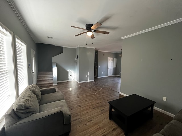 living room with ceiling fan, ornamental molding, and dark hardwood / wood-style floors