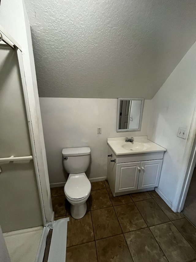 bathroom with lofted ceiling, vanity, toilet, and a textured ceiling