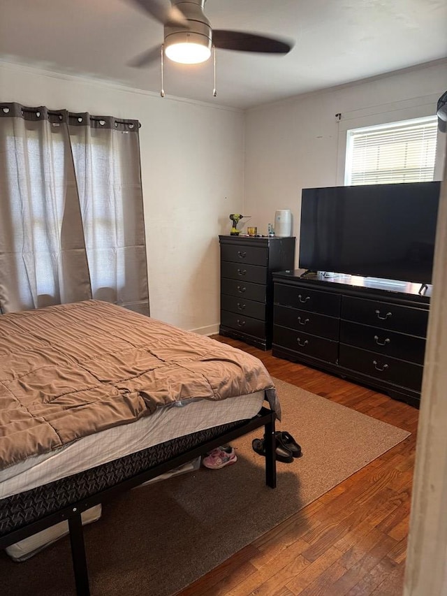 bedroom featuring wood finished floors and ceiling fan