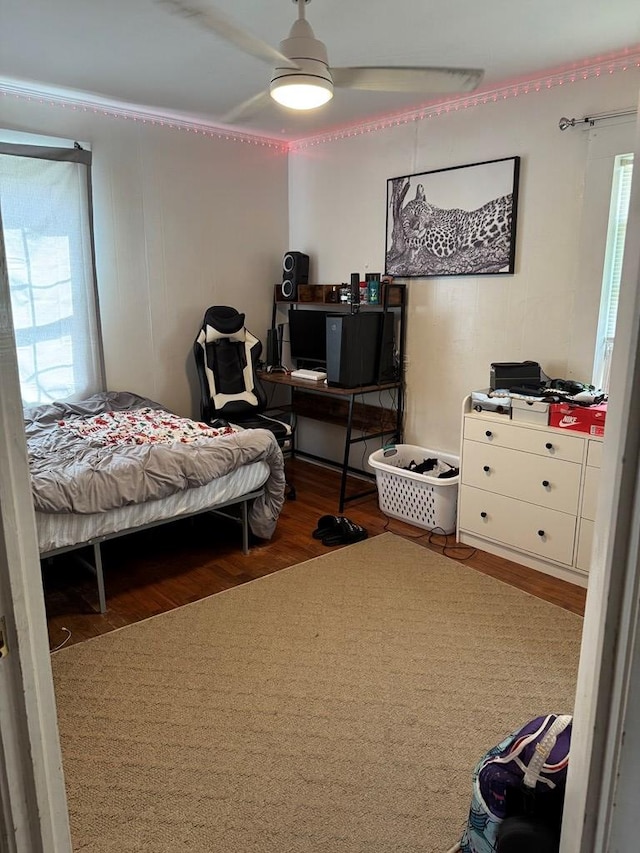 bedroom featuring a ceiling fan and wood finished floors