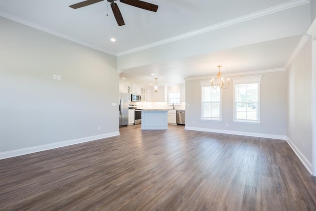 unfurnished living room with recessed lighting, baseboards, ornamental molding, dark wood-type flooring, and ceiling fan with notable chandelier