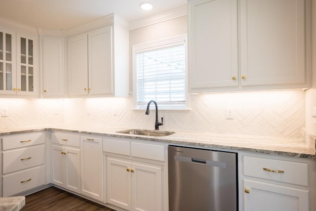 kitchen with a sink, white cabinets, light stone countertops, dishwasher, and glass insert cabinets