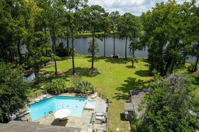 view of swimming pool featuring a patio, a water view, and a yard