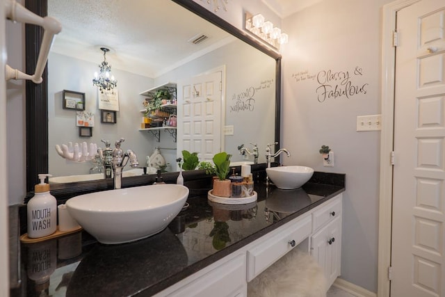 bathroom featuring an inviting chandelier and vanity