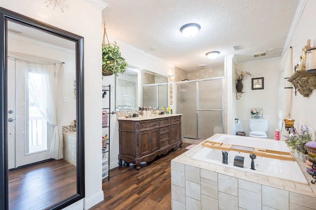 full bathroom with vanity, hardwood / wood-style floors, ornamental molding, and a textured ceiling