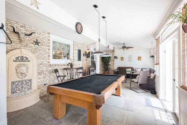 recreation room with brick wall, pool table, and ceiling fan