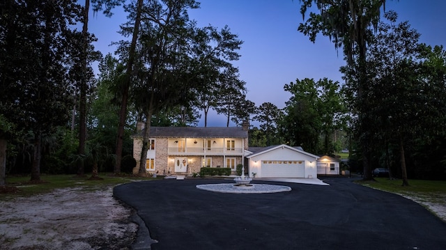 view of front of home featuring a balcony and an outdoor structure