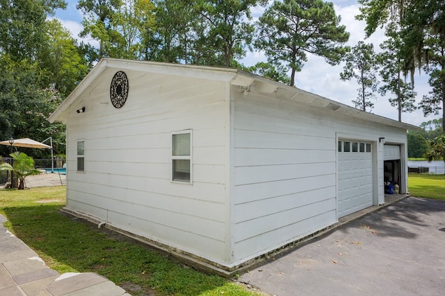 view of property exterior with a garage and an outbuilding