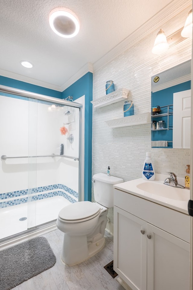 bathroom with crown molding, an enclosed shower, a textured ceiling, and toilet