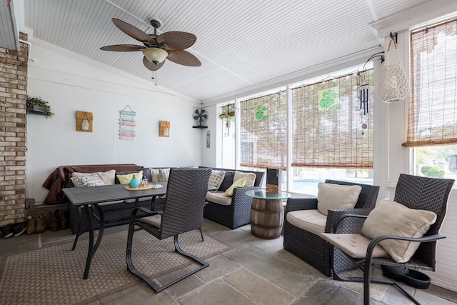 sunroom / solarium featuring lofted ceiling, a healthy amount of sunlight, and ceiling fan