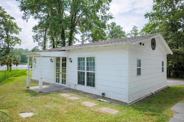 view of side of property with a lawn