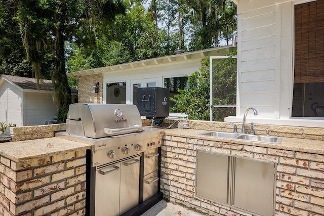 view of patio / terrace with exterior kitchen, sink, and grilling area