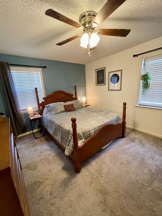 carpeted bedroom with a textured ceiling and a ceiling fan