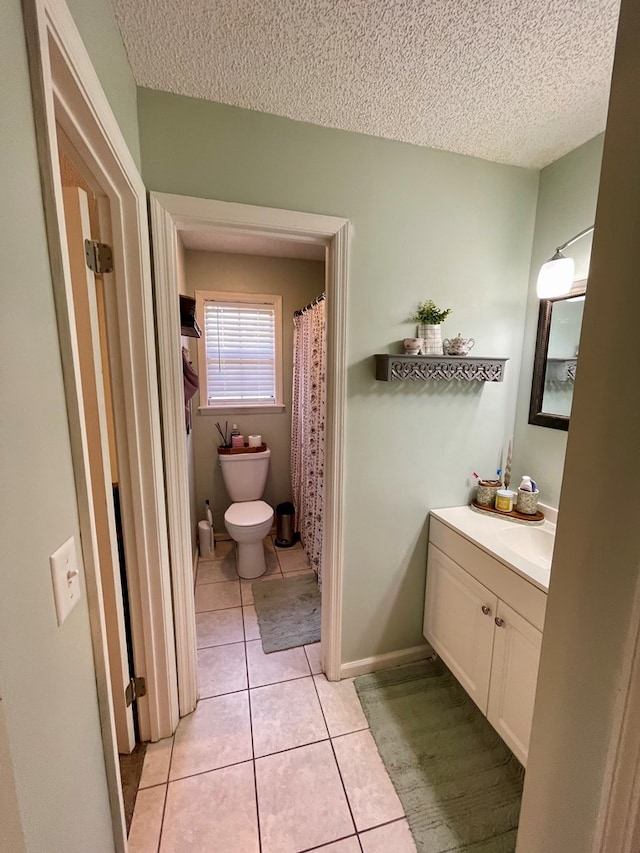 full bathroom with a textured ceiling, vanity, toilet, and tile patterned flooring