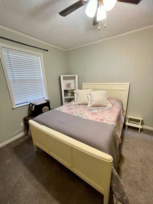 bedroom with dark carpet, a textured ceiling, ceiling fan, and crown molding