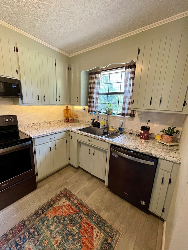 kitchen with electric stove, stainless steel microwave, ornamental molding, a sink, and dishwashing machine