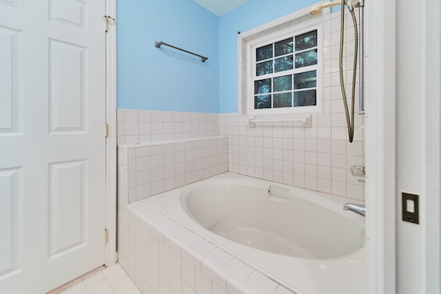 bathroom featuring tiled bath and tile patterned floors