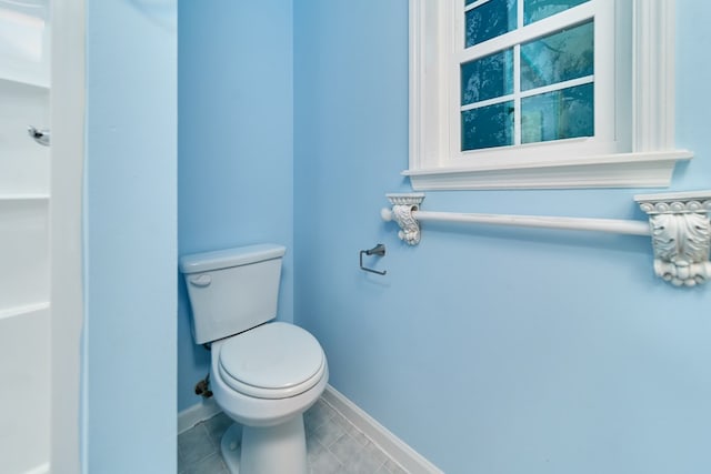 bathroom with tile patterned flooring and toilet