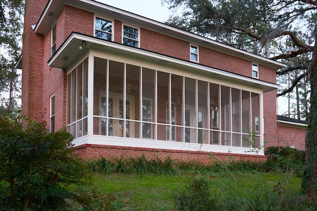 view of property exterior featuring a sunroom