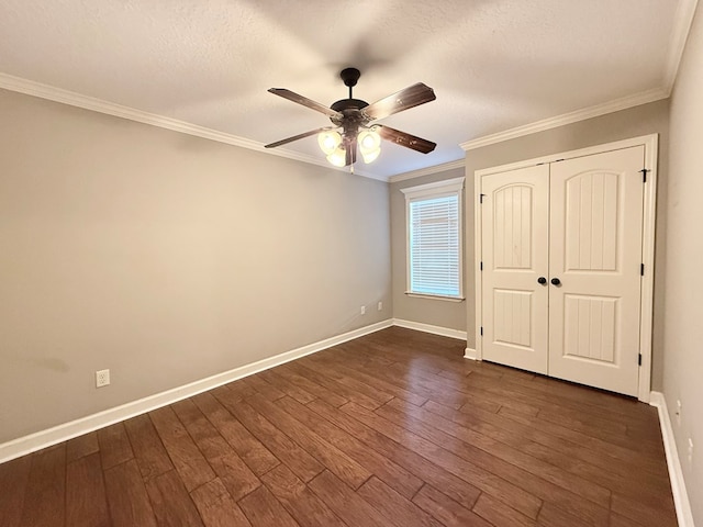 unfurnished bedroom featuring a textured ceiling, dark hardwood / wood-style floors, a closet, ceiling fan, and ornamental molding