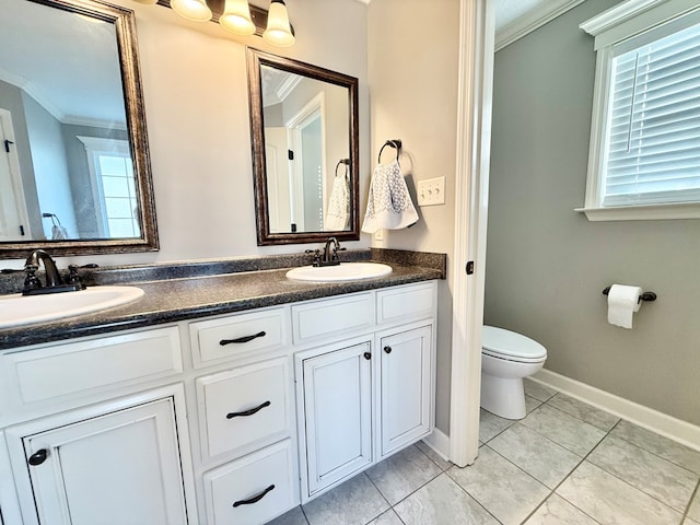 bathroom with tile patterned floors, crown molding, vanity, and toilet