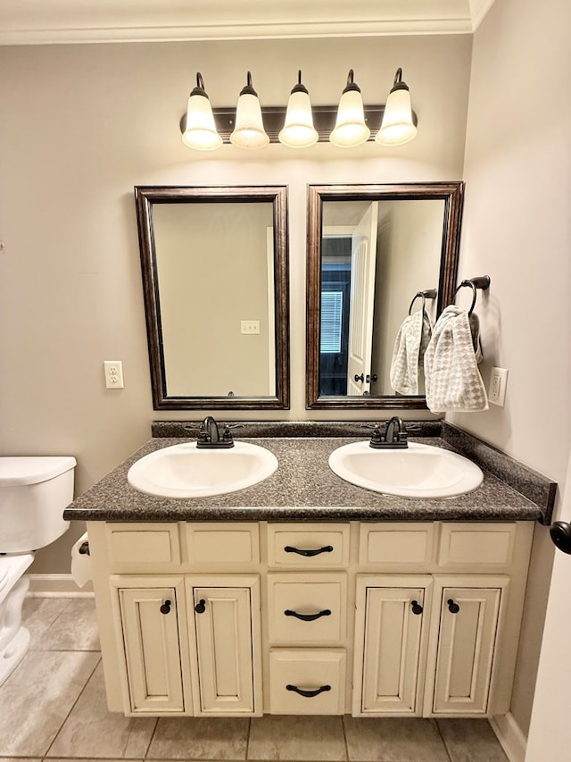 bathroom featuring toilet, tile patterned flooring, crown molding, and vanity