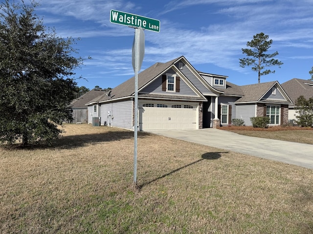 view of front facade with a front yard, a garage, and central AC unit