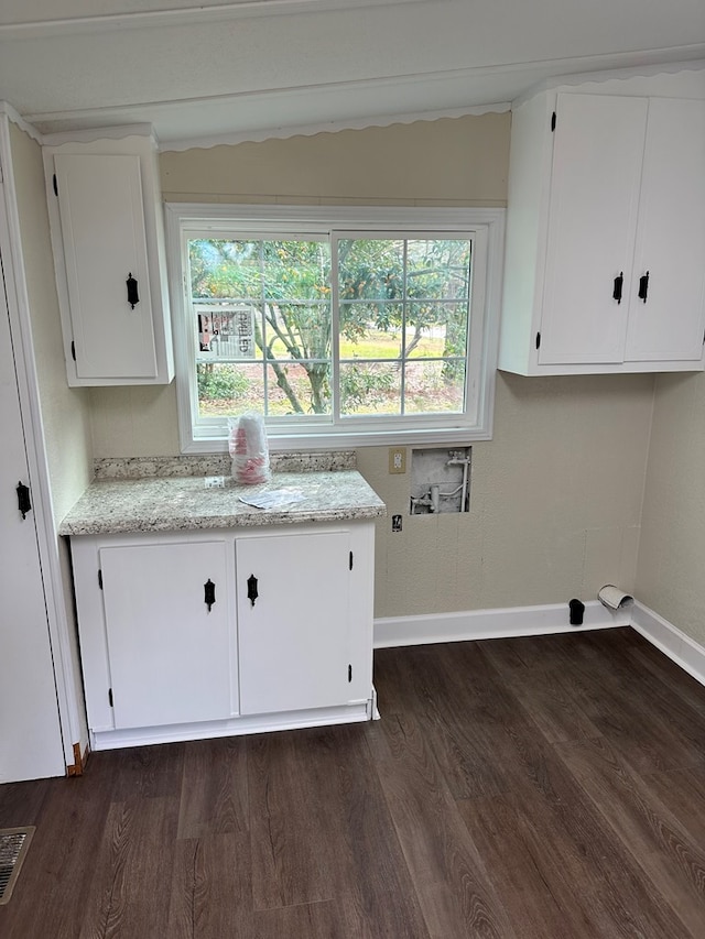 laundry area featuring cabinets, washer hookup, and dark wood-type flooring