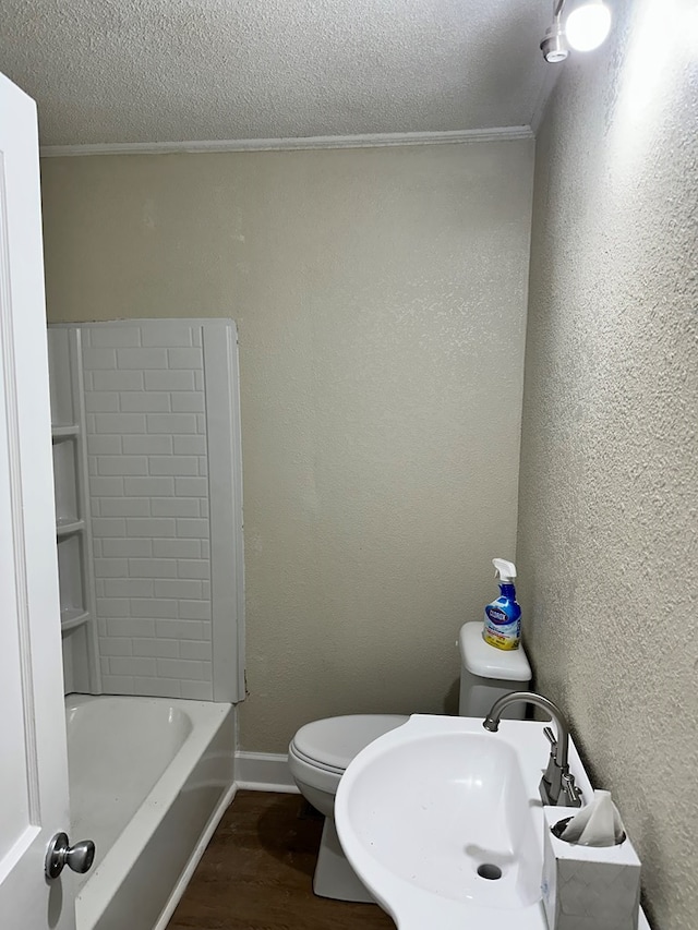 bathroom featuring wood-type flooring, a textured ceiling, and ornamental molding