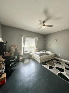 bedroom with a ceiling fan and concrete floors