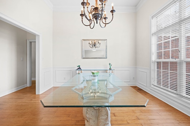 1166 Old Meadow Rd, Valdosta, GA 31605 - dining space featuring a chandelier, crown molding, wood finished floors, and wainscoting