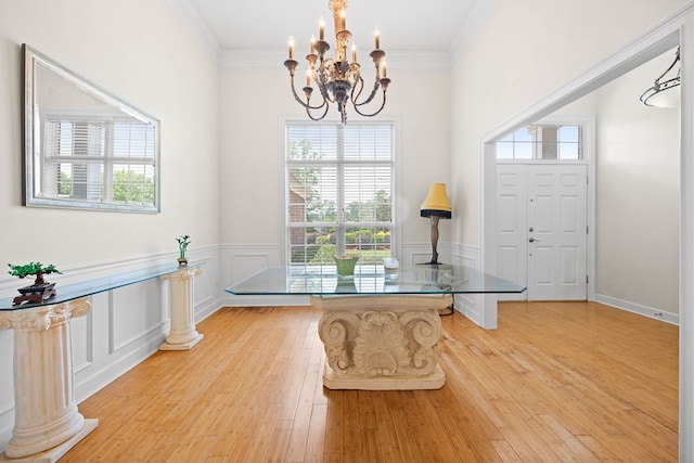 1166 Old Meadow Rd, Valdosta, GA 31605 - entryway with a chandelier, light wood-style floors, ornamental molding, and wainscoting