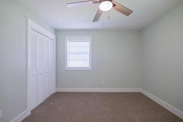 unfurnished bedroom with carpet flooring, ceiling fan, and a closet