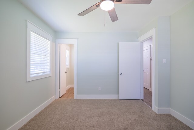 unfurnished bedroom featuring light carpet and ceiling fan