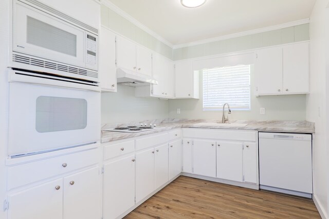 kitchen with white cabinetry, white appliances, and ornamental molding