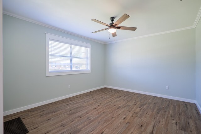 empty room with ceiling fan, dark hardwood / wood-style flooring, and crown molding