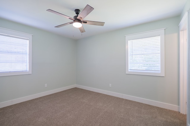 carpeted empty room featuring ceiling fan