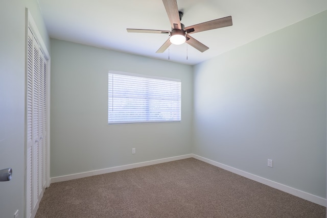 spare room with carpet and ceiling fan