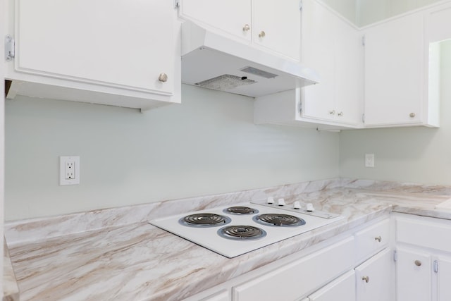 kitchen with white cabinets and white electric cooktop