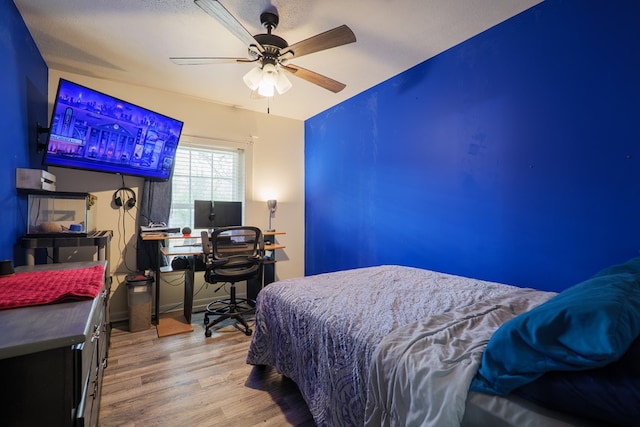 bedroom with wood-type flooring and ceiling fan